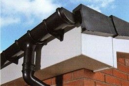 White woodgrain fascia with black cast iron effect rainwater